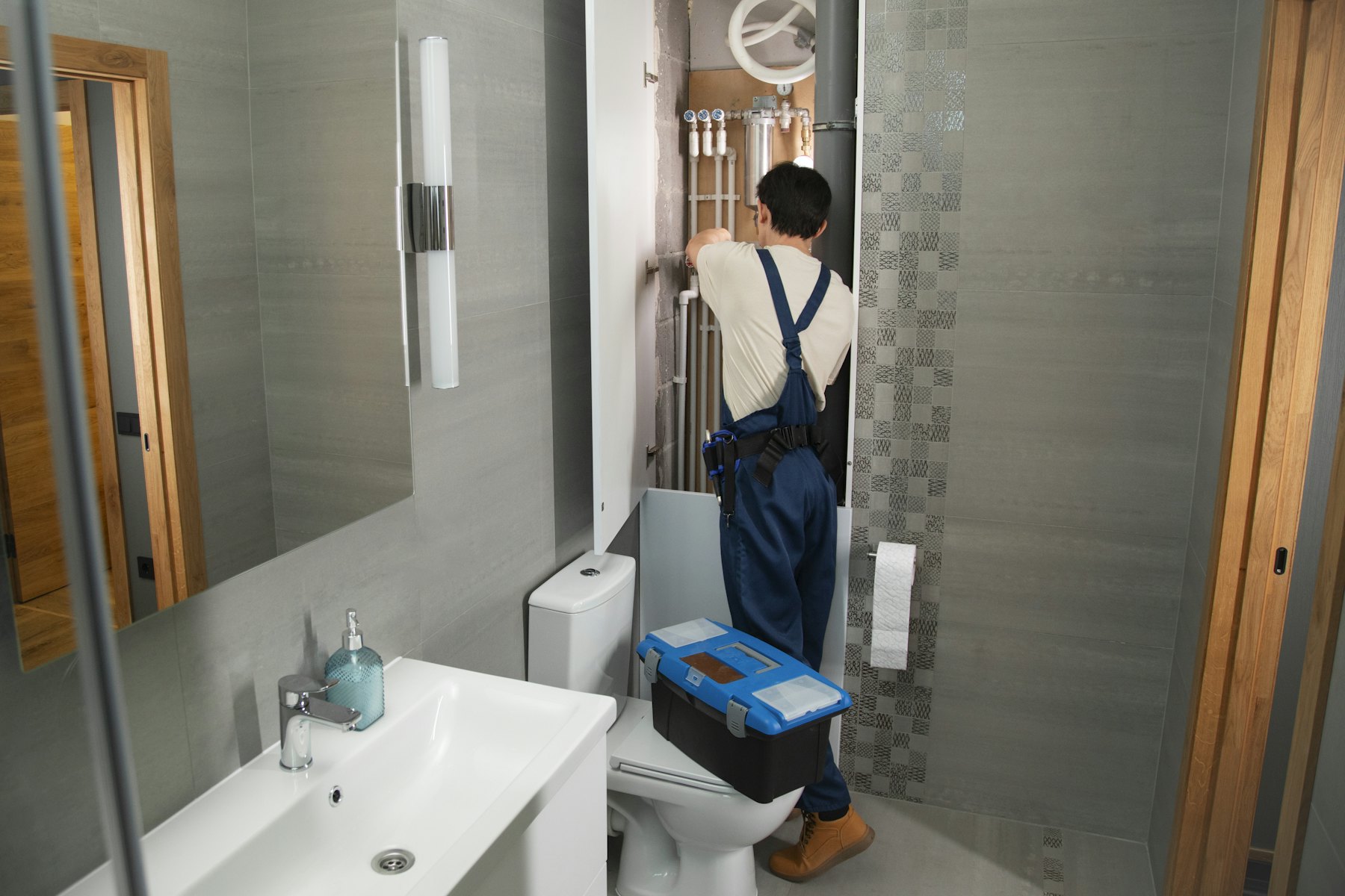 Engineer working on bathroom plumbing